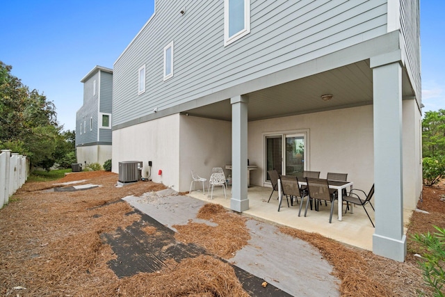 rear view of property with central AC and a patio area