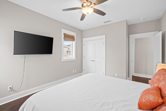 bedroom featuring a closet, ceiling fan, and dark wood-type flooring