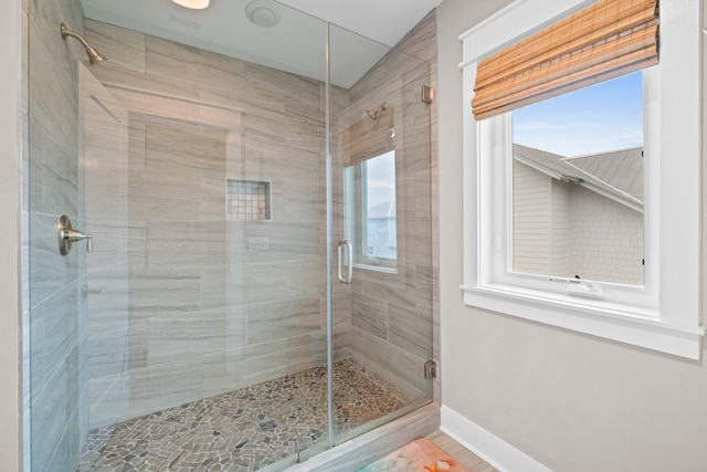 bathroom featuring a healthy amount of sunlight and an enclosed shower