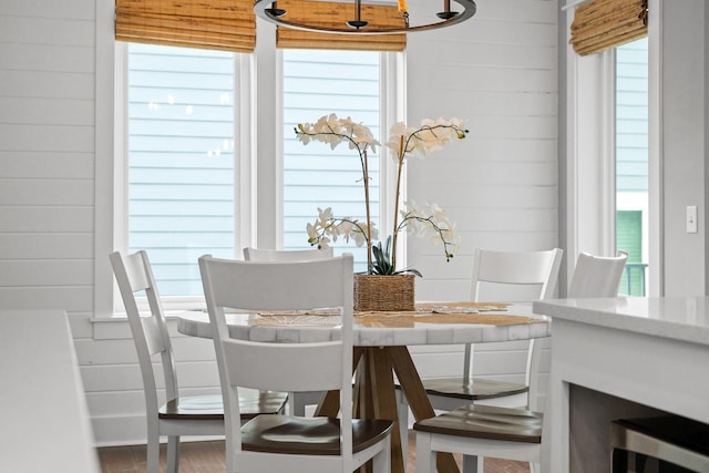 dining room with wooden walls