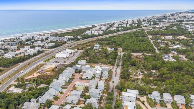 drone / aerial view featuring a beach view and a water view