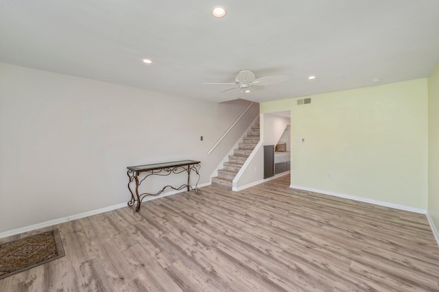 unfurnished living room with ceiling fan and light hardwood / wood-style flooring