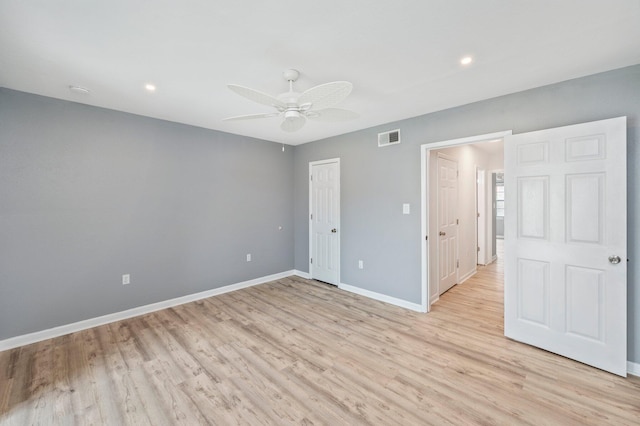 unfurnished bedroom featuring ceiling fan, a closet, and light hardwood / wood-style flooring