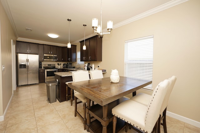 dining room with ornamental molding, sink, light tile patterned floors, and an inviting chandelier