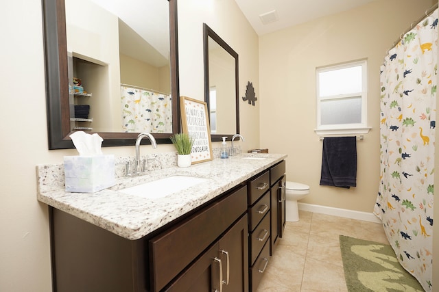 bathroom with tile patterned flooring, vanity, and toilet