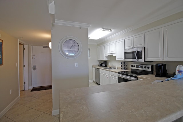 kitchen with sink, white cabinetry, stainless steel appliances, and ornamental molding