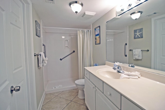 bathroom featuring tile patterned flooring, vanity, toilet, and walk in shower