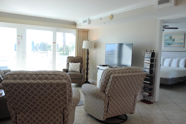 tiled living room featuring ceiling fan and ornamental molding