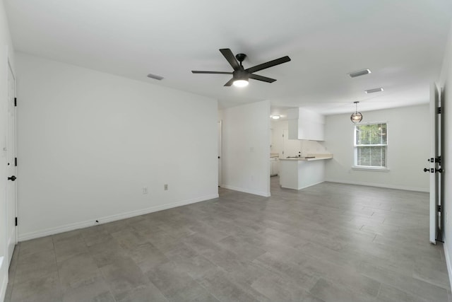 unfurnished living room with ceiling fan