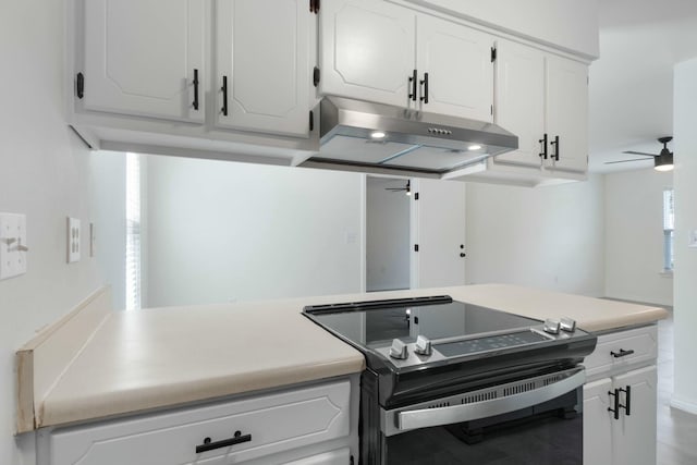 kitchen with electric range, ceiling fan, and white cabinetry