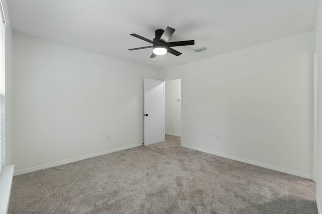 carpeted empty room featuring ceiling fan