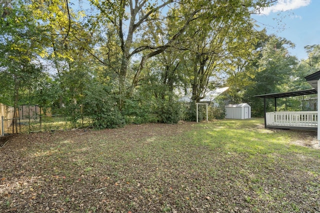 view of yard with a shed and a deck