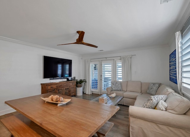 living room featuring ceiling fan, dark hardwood / wood-style flooring, and ornamental molding