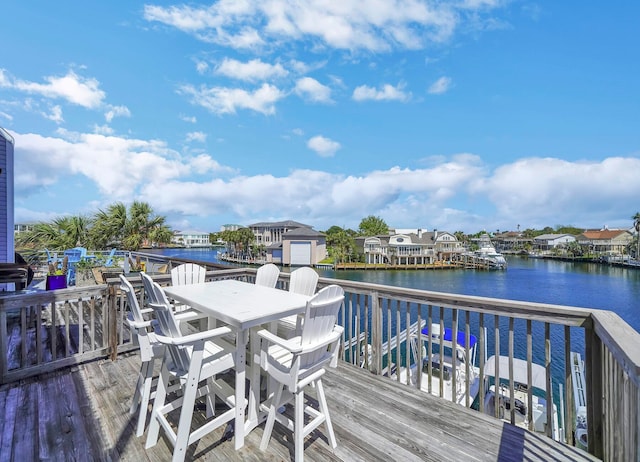 wooden terrace featuring a water view