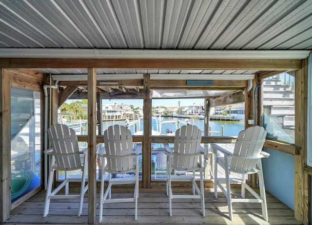 unfurnished sunroom with a wealth of natural light and a water view