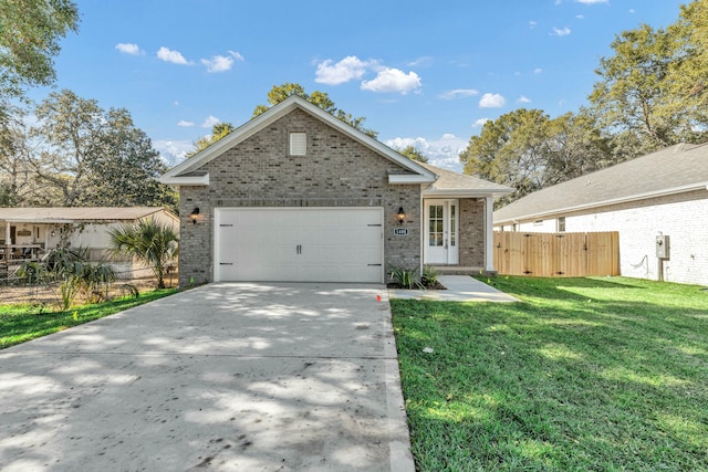 view of front of property featuring a garage and a front lawn