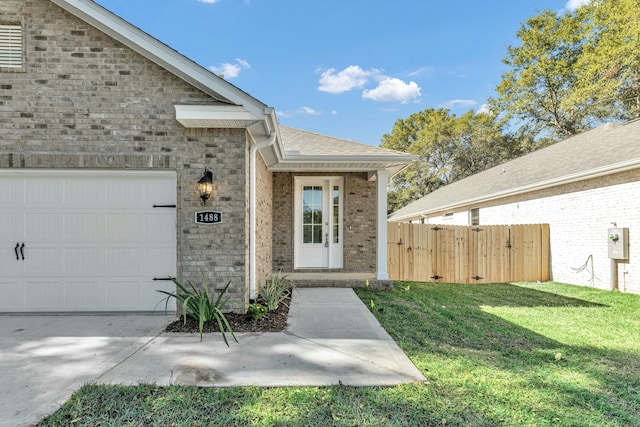 doorway to property featuring a lawn and a garage