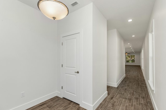 corridor featuring dark wood-type flooring