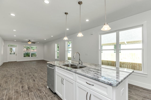 kitchen with ceiling fan, sink, dark wood-type flooring, an island with sink, and white cabinets