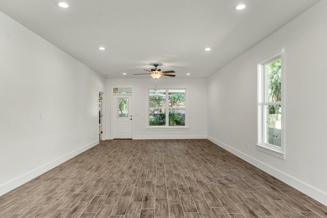 unfurnished living room featuring hardwood / wood-style floors, ceiling fan, and a wealth of natural light