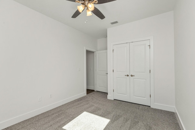 unfurnished bedroom with carpet, ceiling fan, and a closet