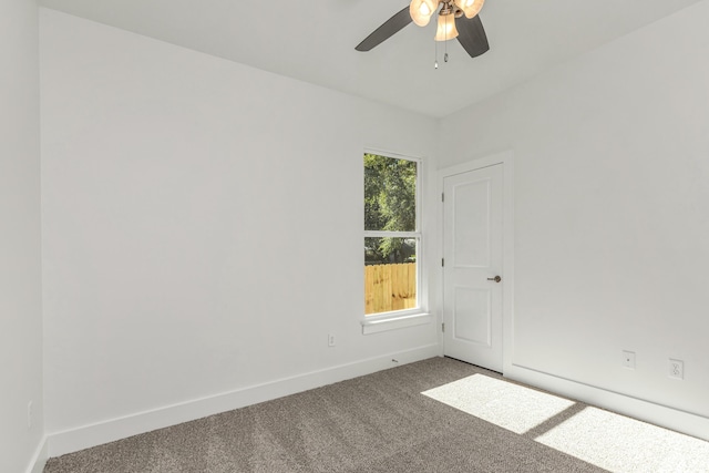 carpeted spare room featuring ceiling fan