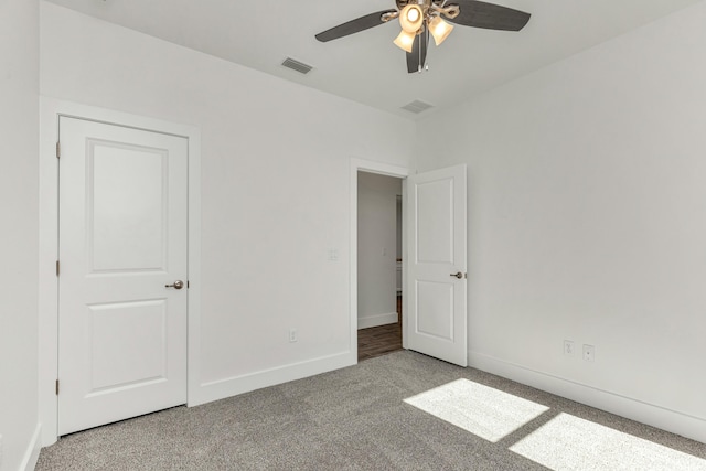 unfurnished bedroom with carpet floors and ceiling fan