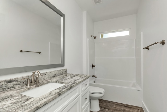 full bathroom featuring washtub / shower combination, wood-type flooring, vanity, and toilet