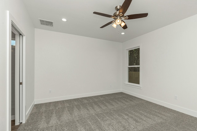 carpeted spare room with ceiling fan