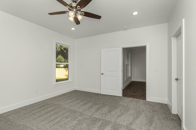 unfurnished bedroom featuring ceiling fan and carpet