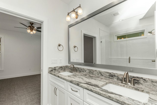 bathroom featuring ceiling fan, vanity, and a shower with shower door