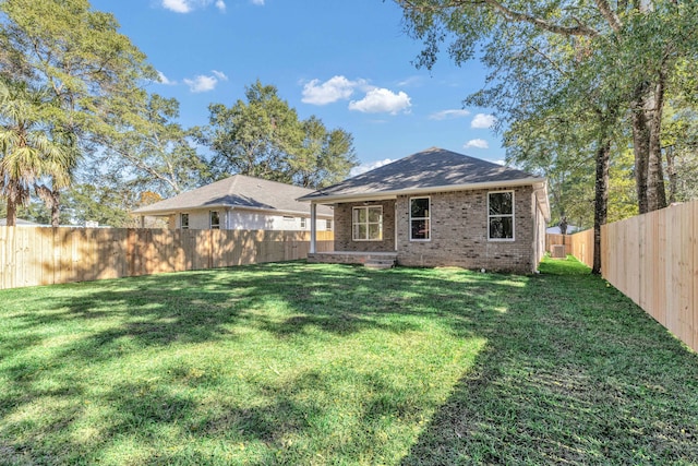 back of house with a lawn