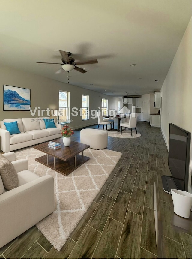 living room with baseboards, a ceiling fan, and wood finish floors