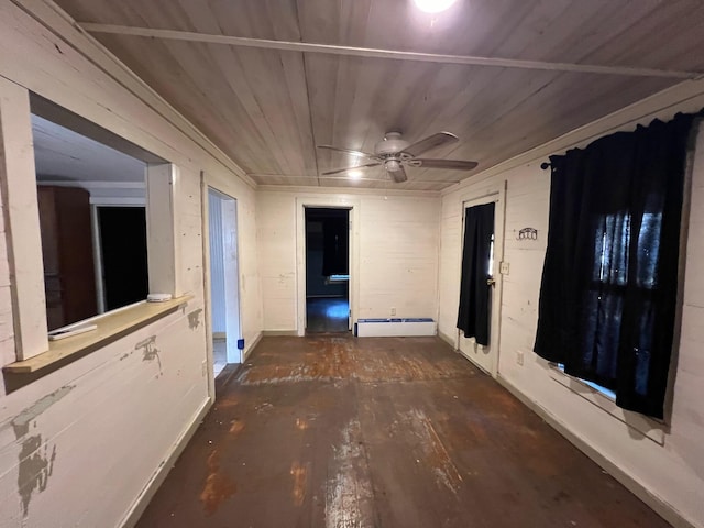 interior space featuring baseboard heating, wooden ceiling, and wood walls