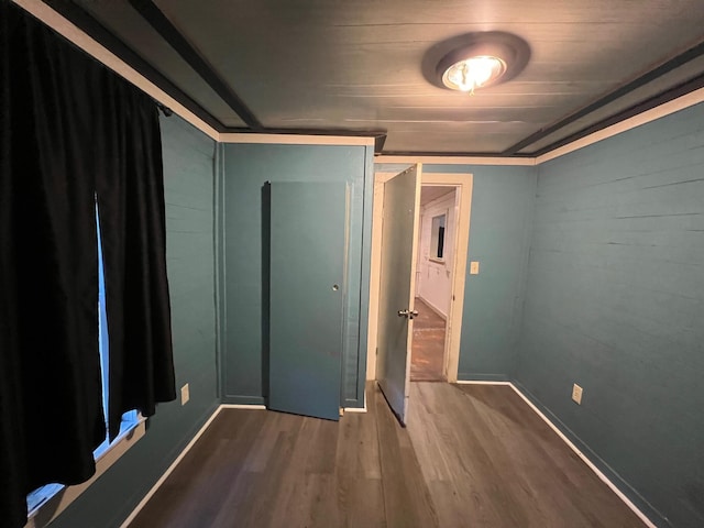 unfurnished bedroom featuring dark hardwood / wood-style flooring