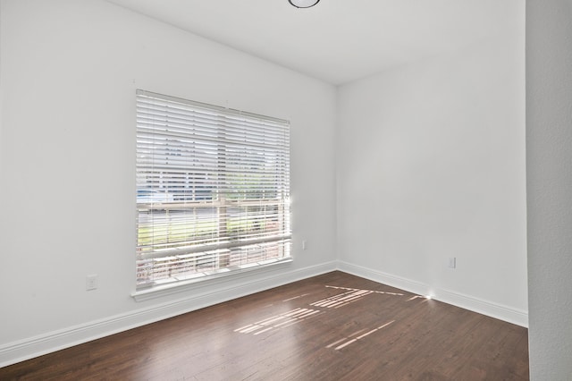 empty room with dark hardwood / wood-style floors