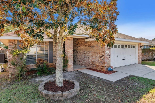 9761 Leeward Way, Navarre, FL 32566 - view of front of home with brick siding, concrete driveway, and a garage