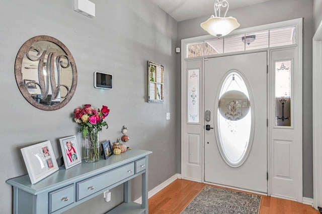 9761 Leeward Way, Navarre, FL 32566 - foyer with light wood-style floors and baseboards