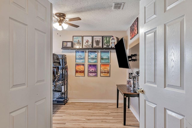 9761 Leeward Way, Navarre, FL 32566 - hall with light wood-type flooring, a textured ceiling, and baseboards