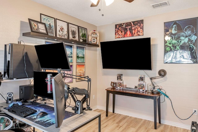 office area with a textured ceiling, hardwood / wood-style flooring, and ceiling fan