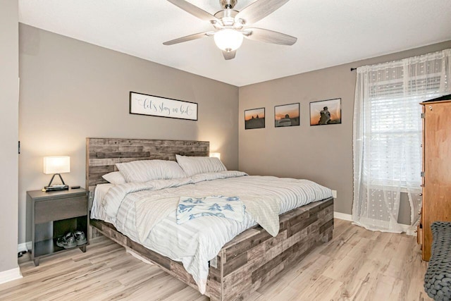 bedroom with ceiling fan and light hardwood / wood-style flooring