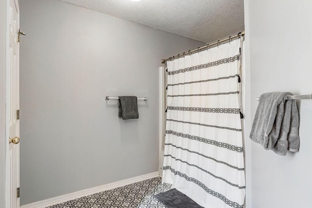 9761 Leeward Way, Navarre, FL 32566 - bathroom with baseboards, a textured ceiling, and a shower with curtain