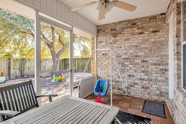 sunroom / solarium featuring ceiling fan