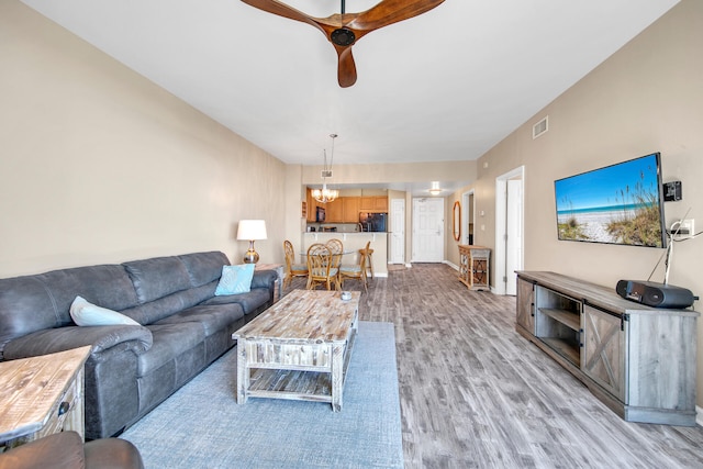 4203 Indian Bayou Trl Unit 11207, Destin, FL 32541 - living area featuring ceiling fan, light wood-style flooring, and a chandelier