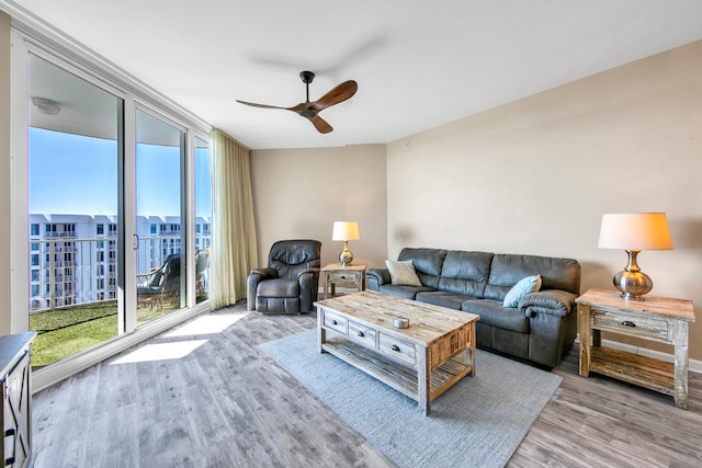 living room with light hardwood / wood-style floors and ceiling fan