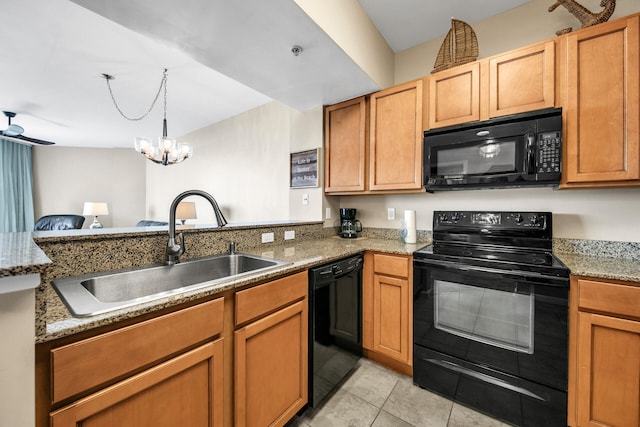 kitchen with light stone countertops, ceiling fan with notable chandelier, sink, black appliances, and light tile patterned flooring