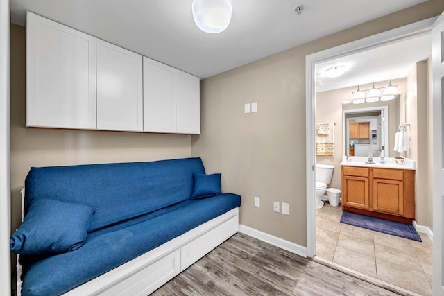 living area featuring sink and light hardwood / wood-style floors