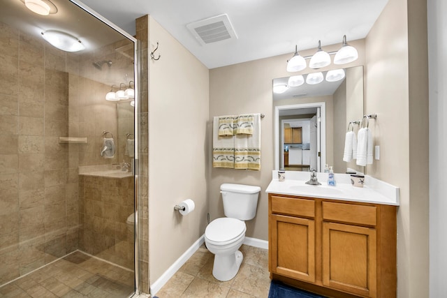 bathroom featuring tile patterned flooring, vanity, an enclosed shower, and toilet