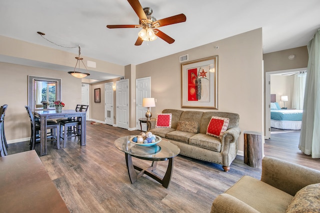 living room featuring hardwood / wood-style flooring and ceiling fan