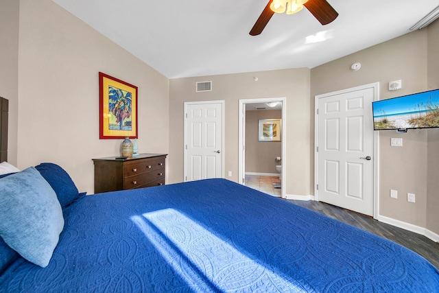 4207 Indian Bayou Trl Unit 2216, Destin, FL 32541 - bedroom featuring baseboards, wood finished floors, connected bathroom, and a ceiling fan